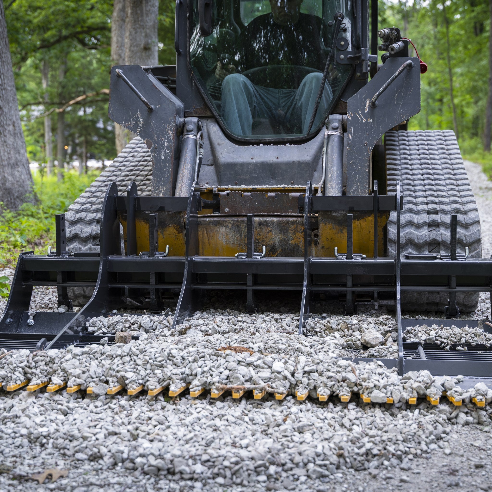 Land planer grading a gravel driveway