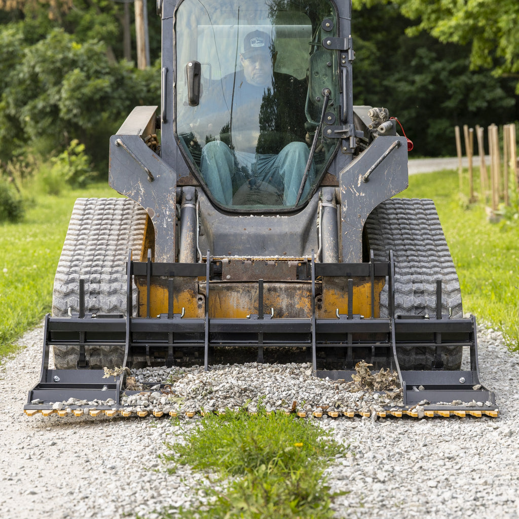 Land planer leveling a gravel drive