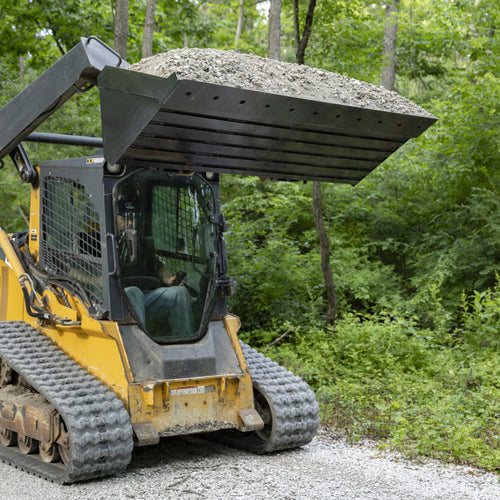 Standard bucket raised with a full load of gravel