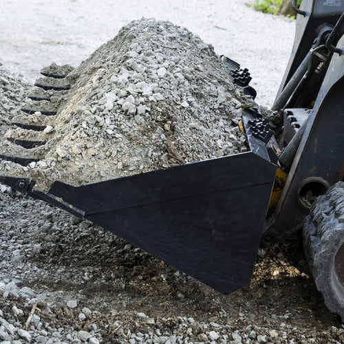 Tooth bucket with a heaping load of gravel