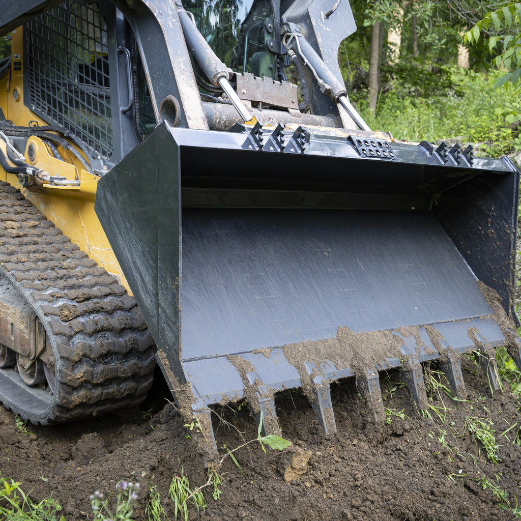 Tooth bucket ripping into packed soil