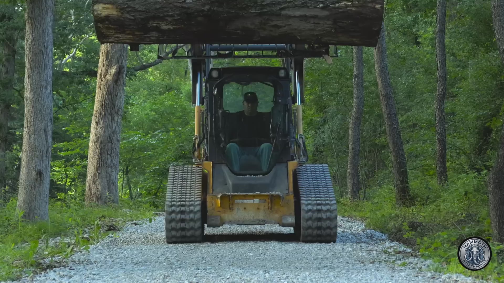 Mammoth 72 inch rock grapple lifting a log on a skid steer