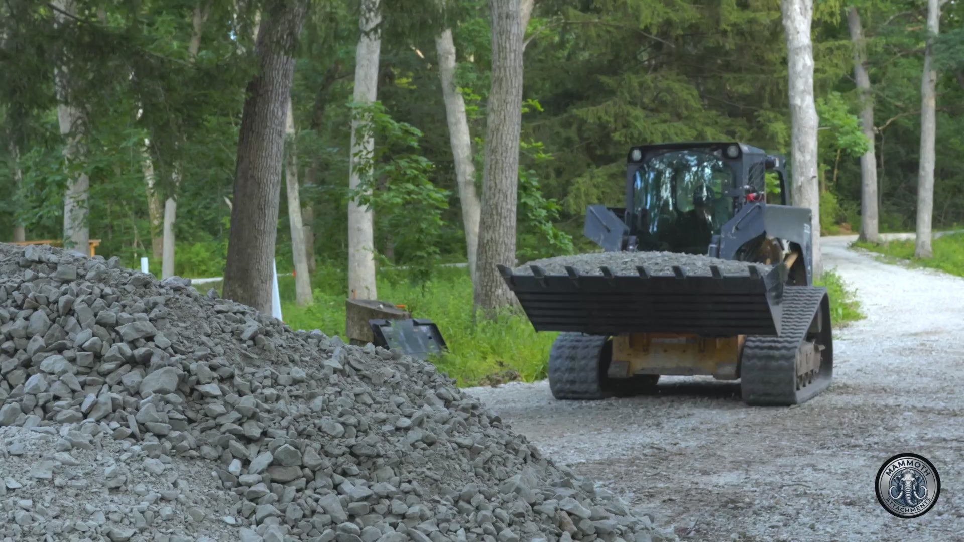 Mammoth 72 inch tooth bucket digging and carrying a loaded bucket